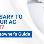 A technician wearing gloves cleans a wall mounted air conditioner with a spray bottle under the headline, "Is it necessary to service your AC every year? A Denver Homeowner's Guide.
